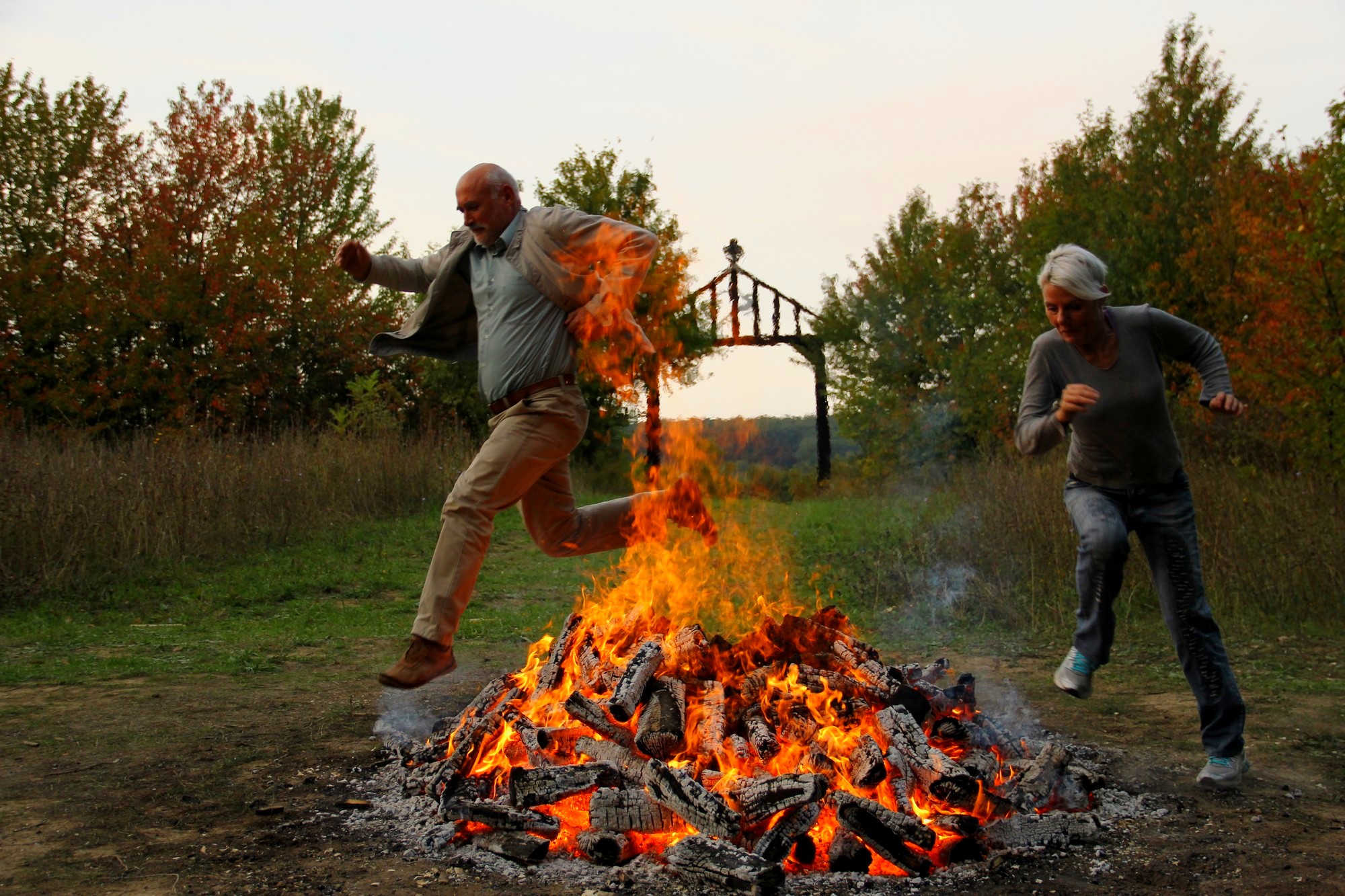 Two participants choosing their own movement across a ceremonial fire
