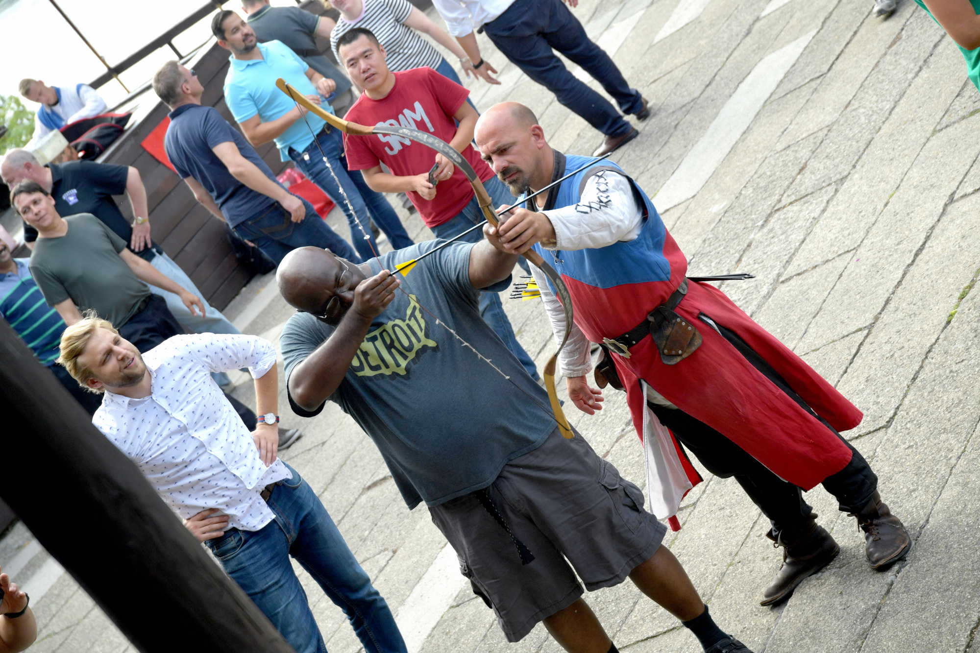 An international executive team learning traditional archery with Napkapu