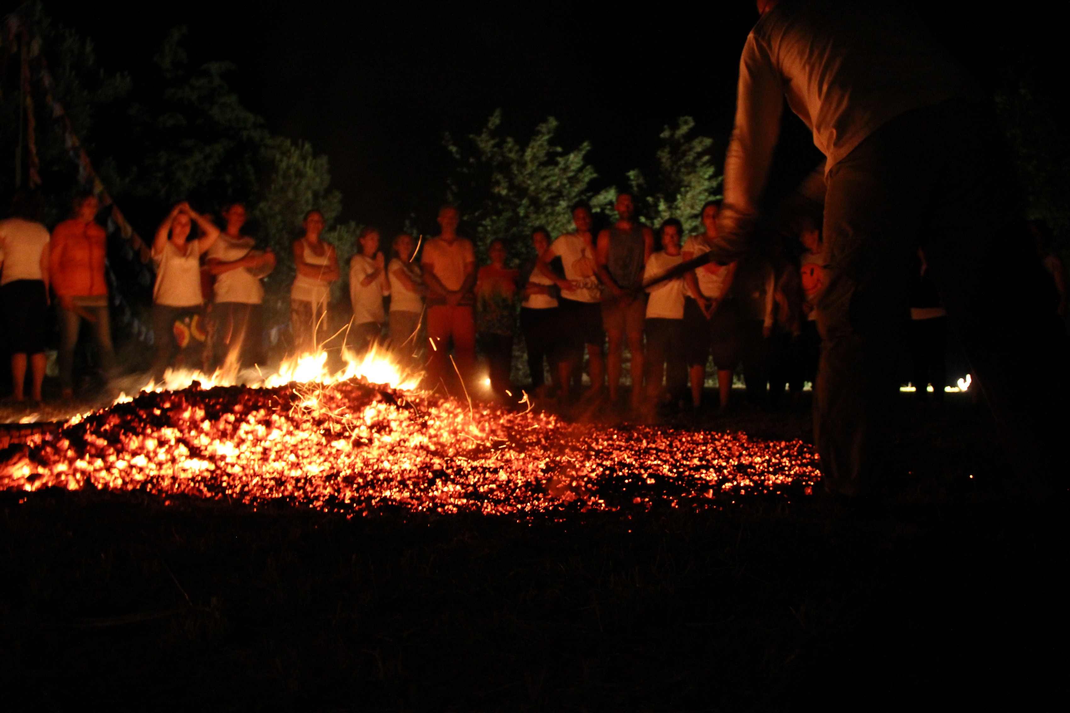 Glowing embers with the group watching in the background