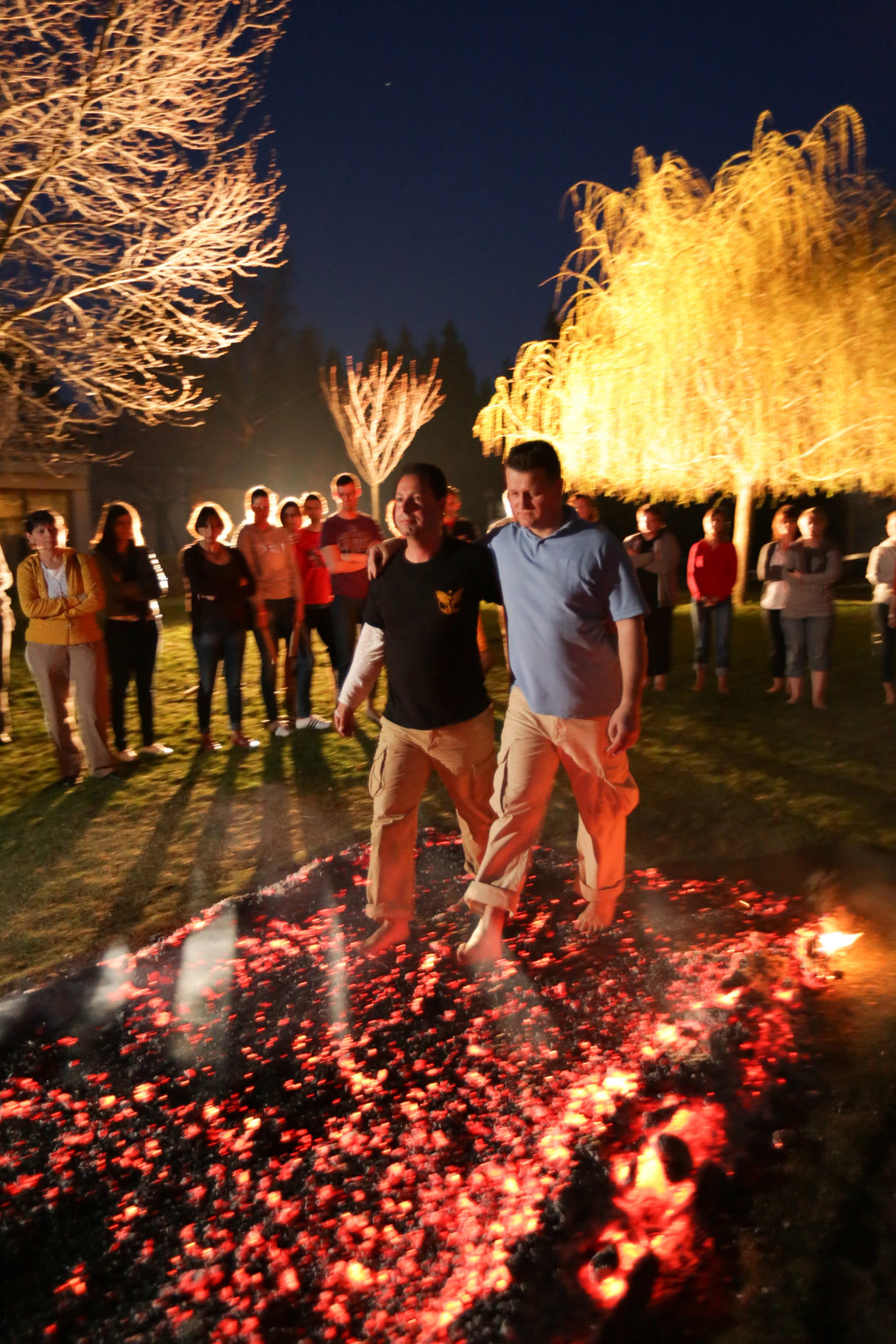 Two colleagues walking together across the hot coals