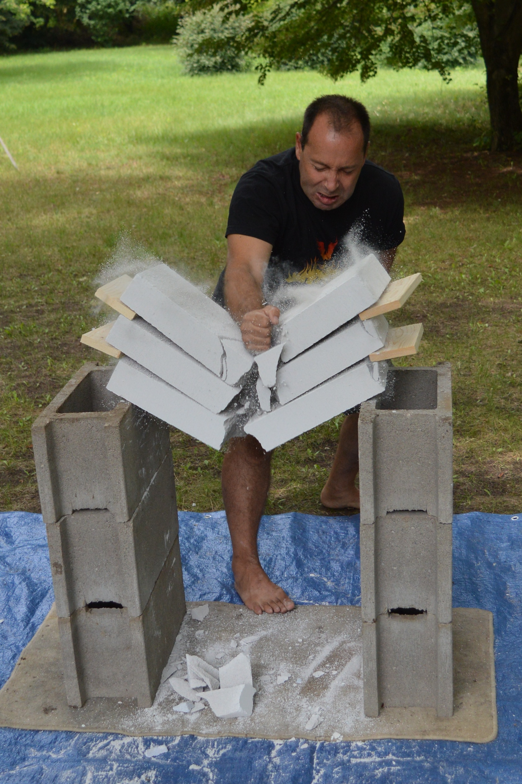 A participant breaking a stack of blocks with his bare hand