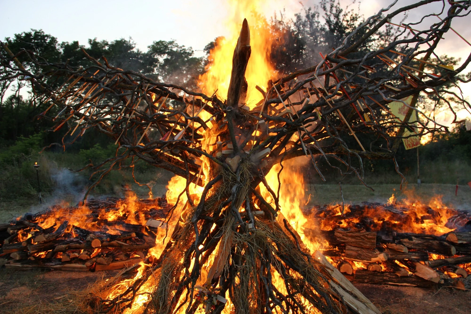 A winged fire sculpture burning at a Four Seasons Firewalk