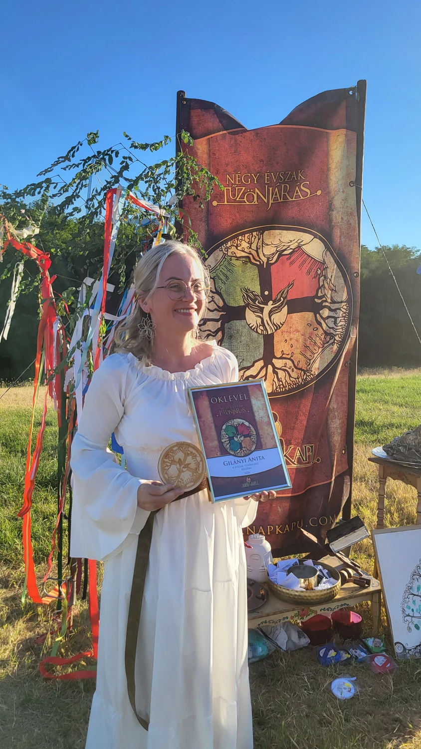 A participant holding her Four Seasons Firewalker certificate and recognition
