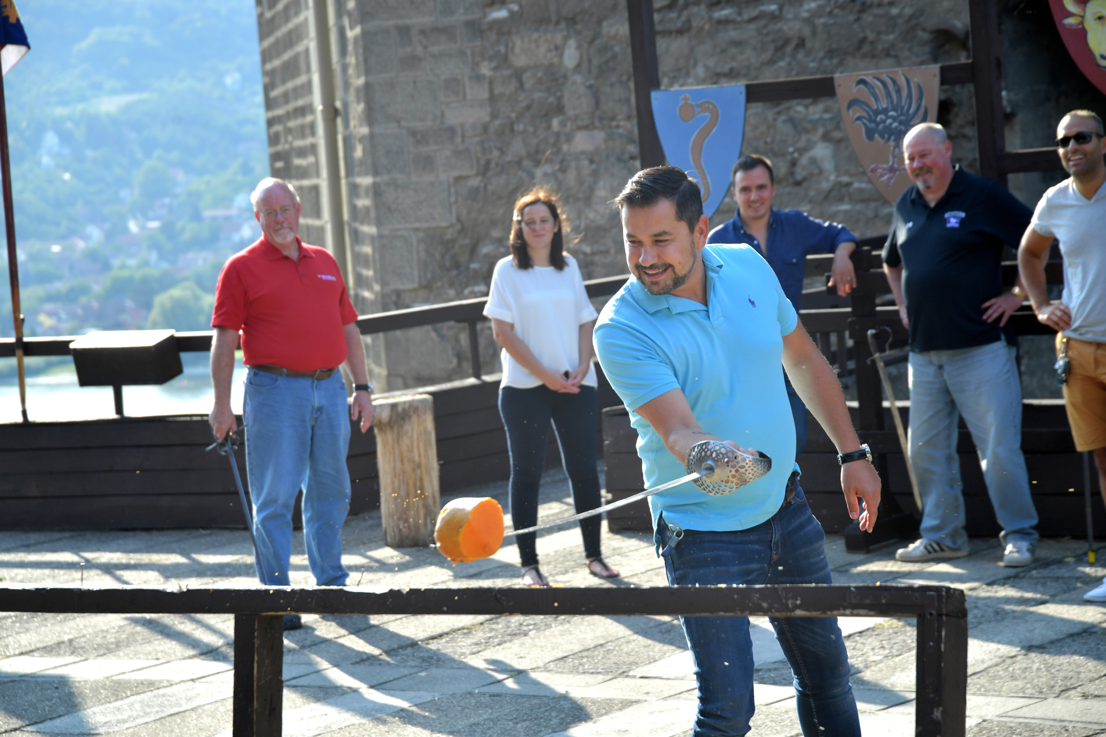 A participant completing a supported striking challenge while colleagues observe