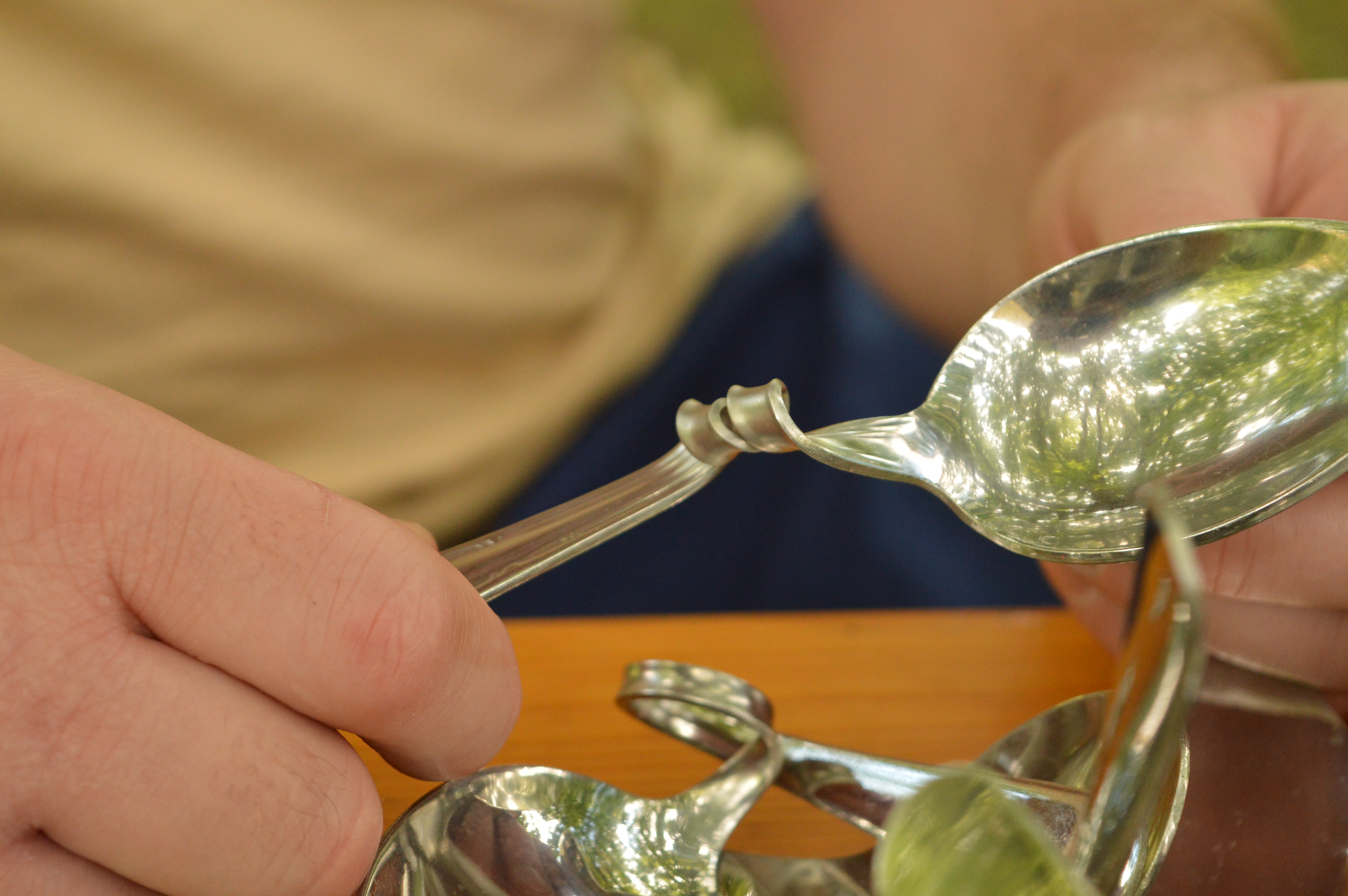 Close-up of a participant holding a spoon tied into a knot
