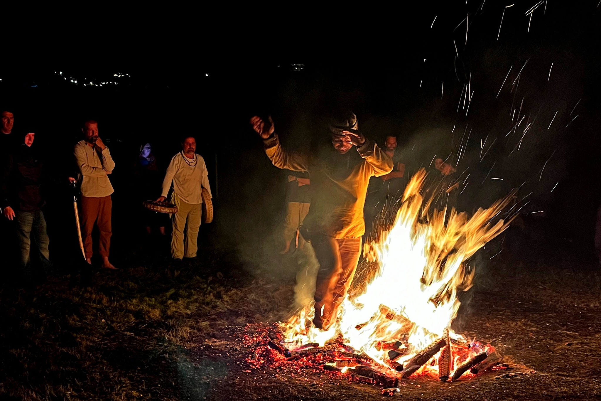 Bence László Tarr stepping into the flames as the group watches