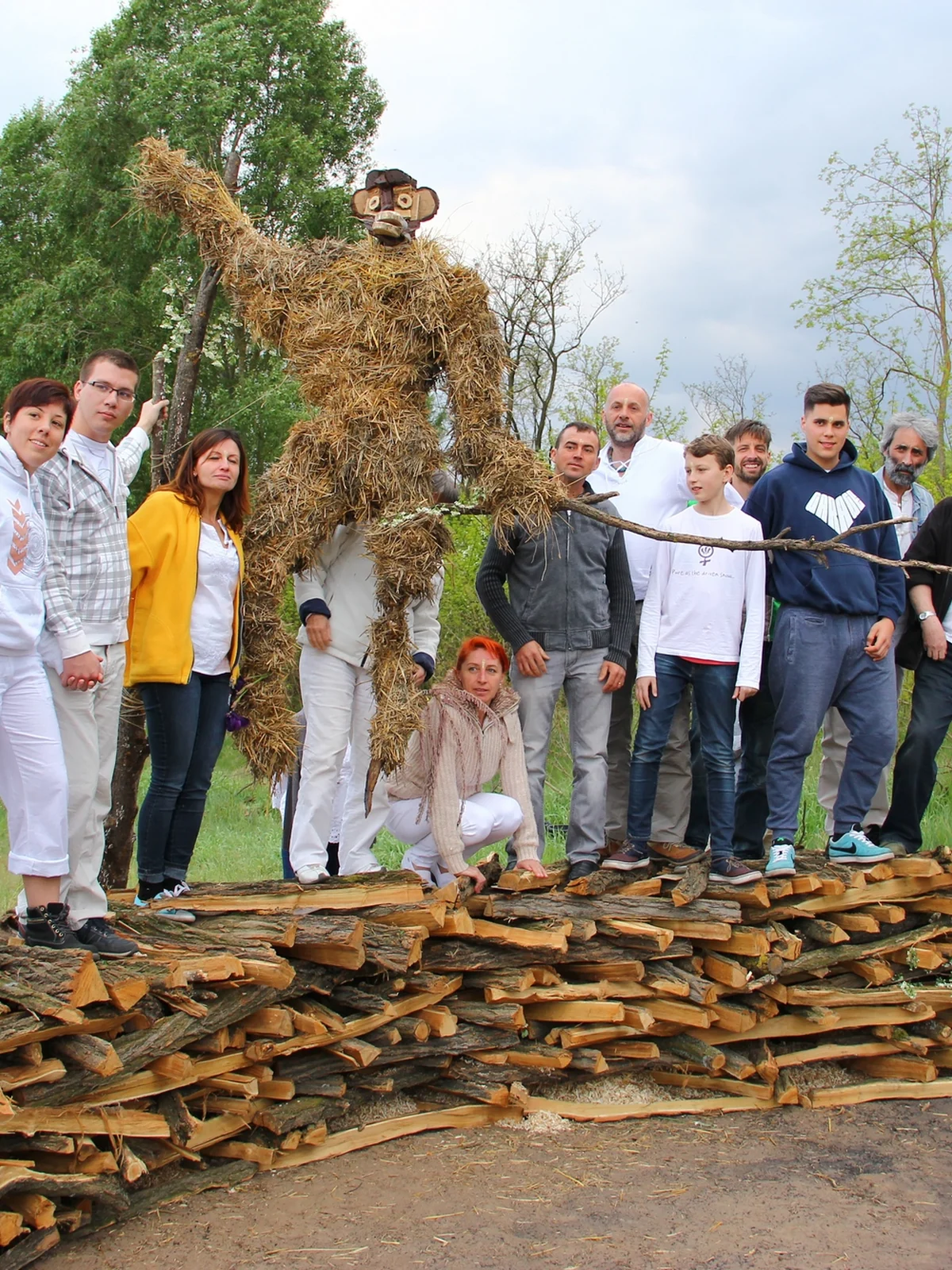 A group preparing together beside a fire sculpture