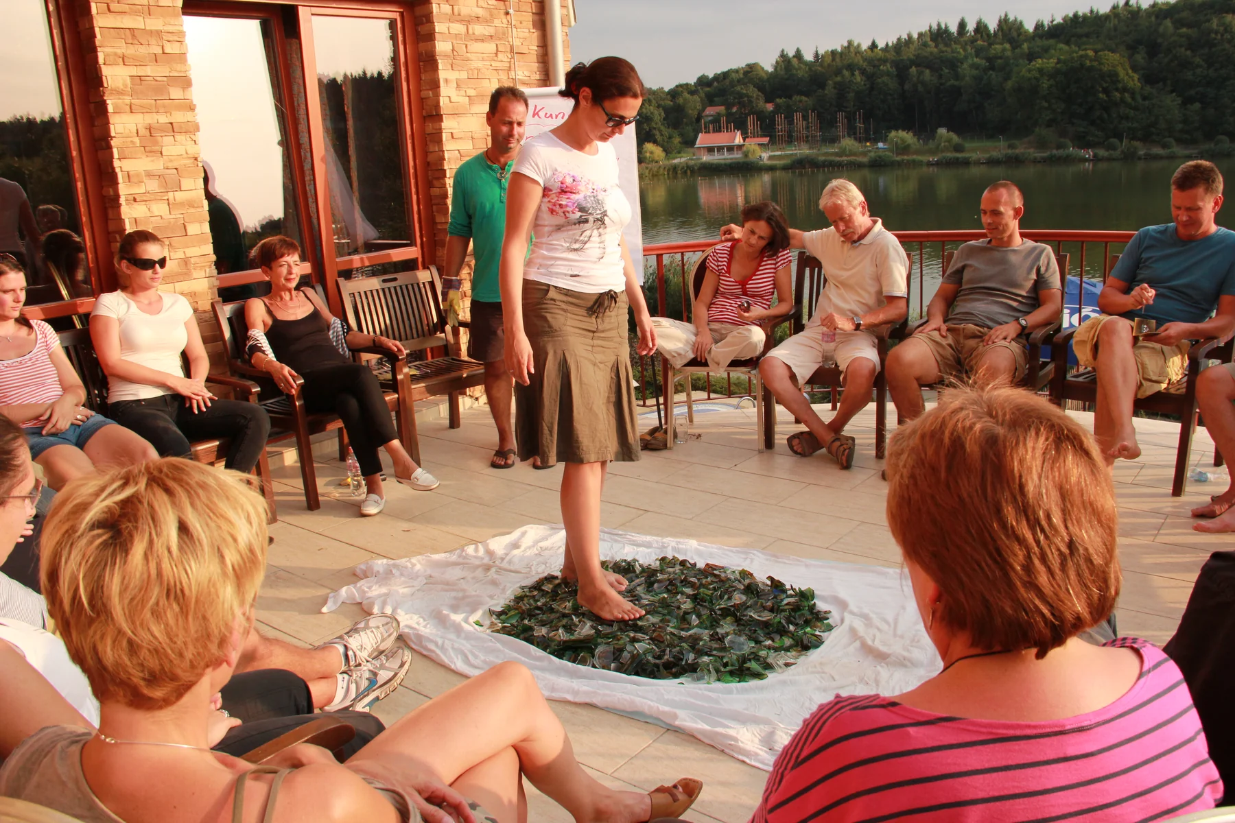 A group supporting a participant during a guided glasswalking exercise