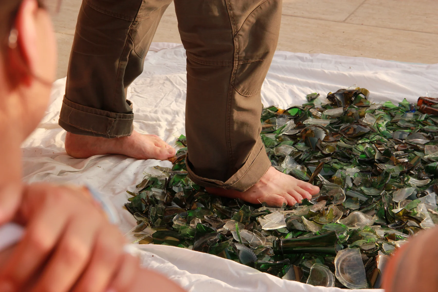 A bare foot finding its first step onto a prepared glasswalking path
