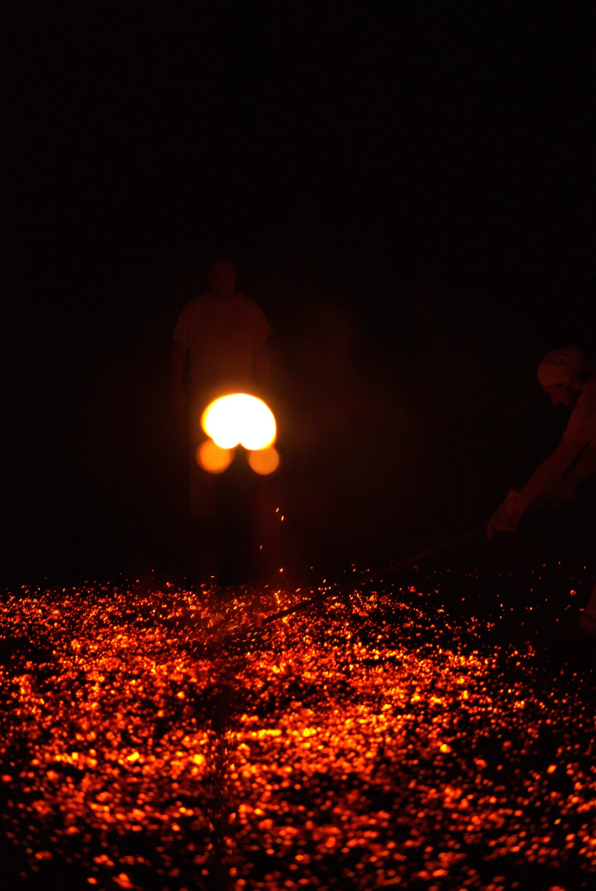 A burning torch glowing above a carefully prepared bed of embers